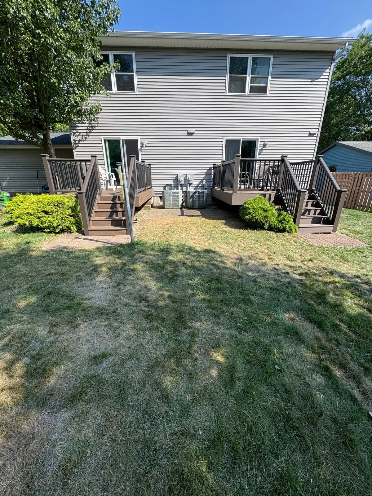 Two composite deck stair landings at the back of a home