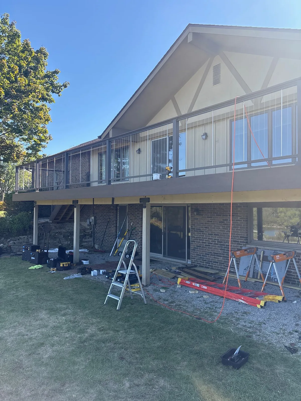 Long raised deck with dark posts and metal mesh railing