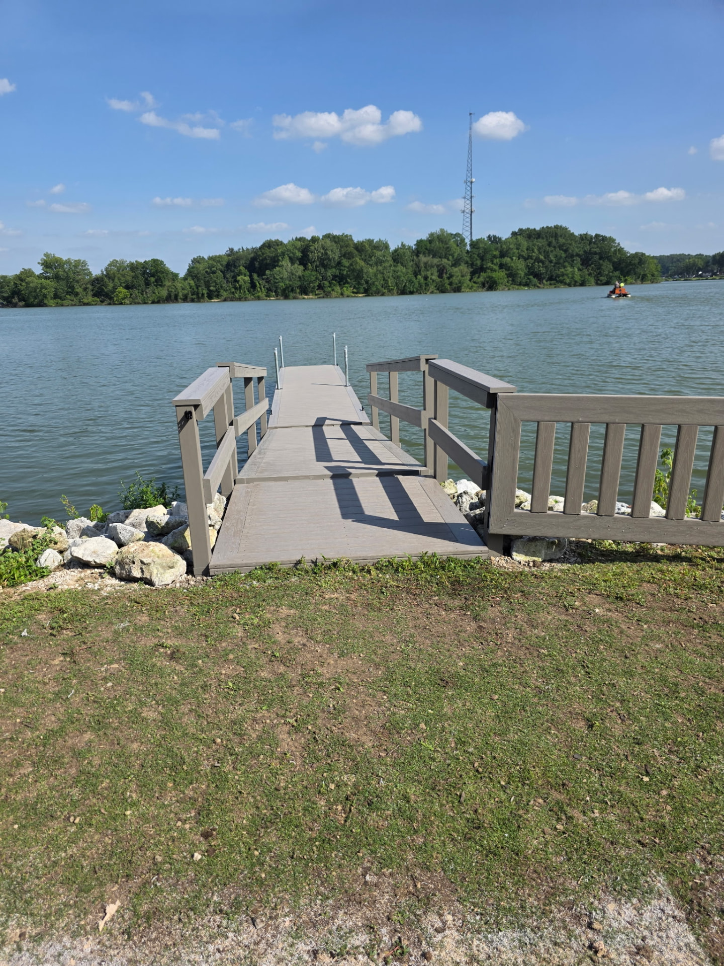 Dock walkway with wood railings leading into an Ohio lake